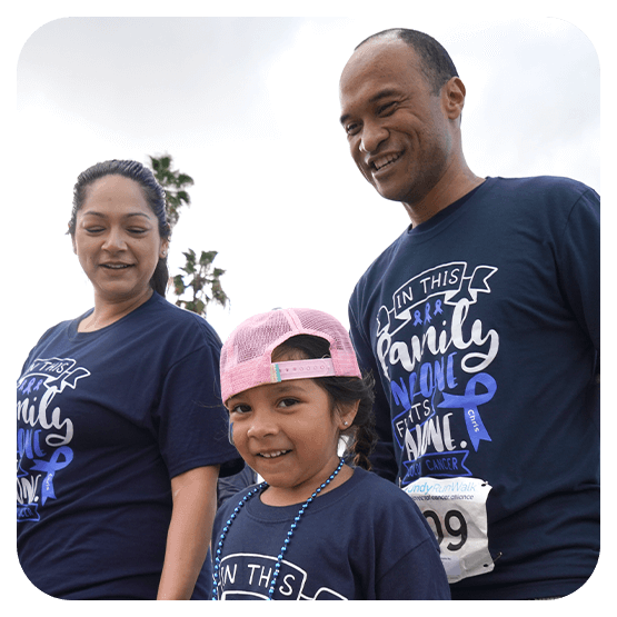 Image of a latinx/hispanic mom, dad, and daughter wearing blue outfits